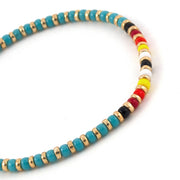 Bracelet Joie de couleur turquoise avec centre multicolore et or.